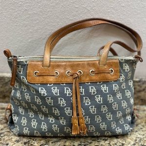 Classic Dooney & Bourke satchel. Monogram canvas exterior with leather straps.
